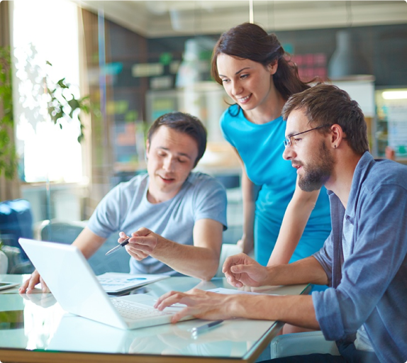 team talking behind laptop
