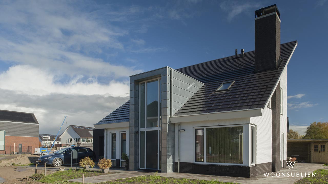 Moderne woning in Culemborg met opvallend risaliet uitgevoerd in zinken felsplaten en grote glazen pui, ontworpen door WoonSubliem.